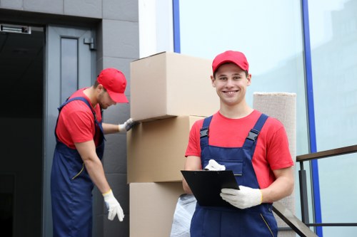 Small removals team handling furniture in Earlscourt