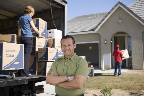 Professional removals team handling furniture carefully for storage